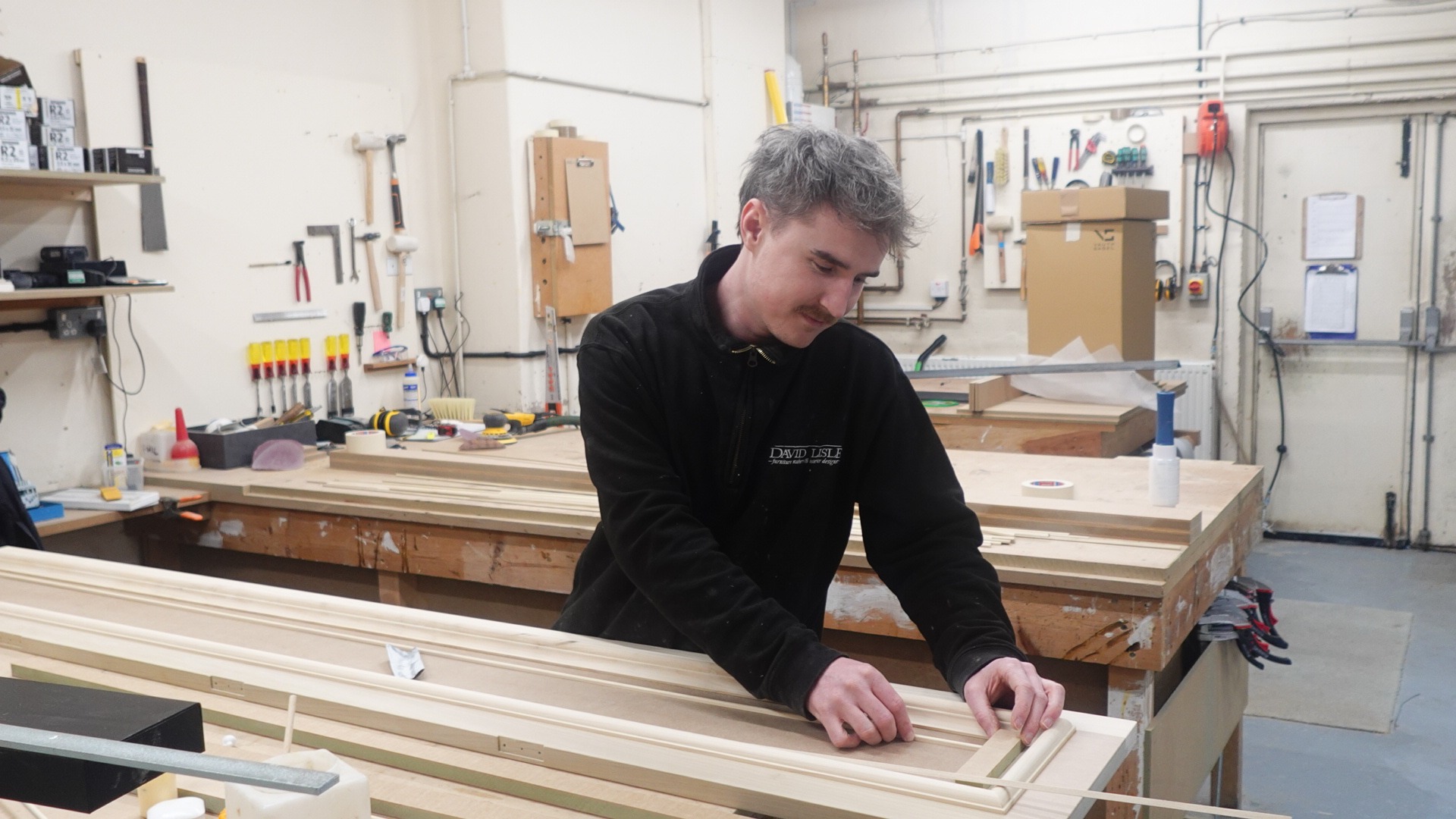 A tradesman working on a David Lisle luxury kitchen for a client in Alderley Edge