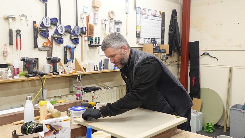 A tradesman working on a David Lisle luxury kitchen for a client in Bramhall