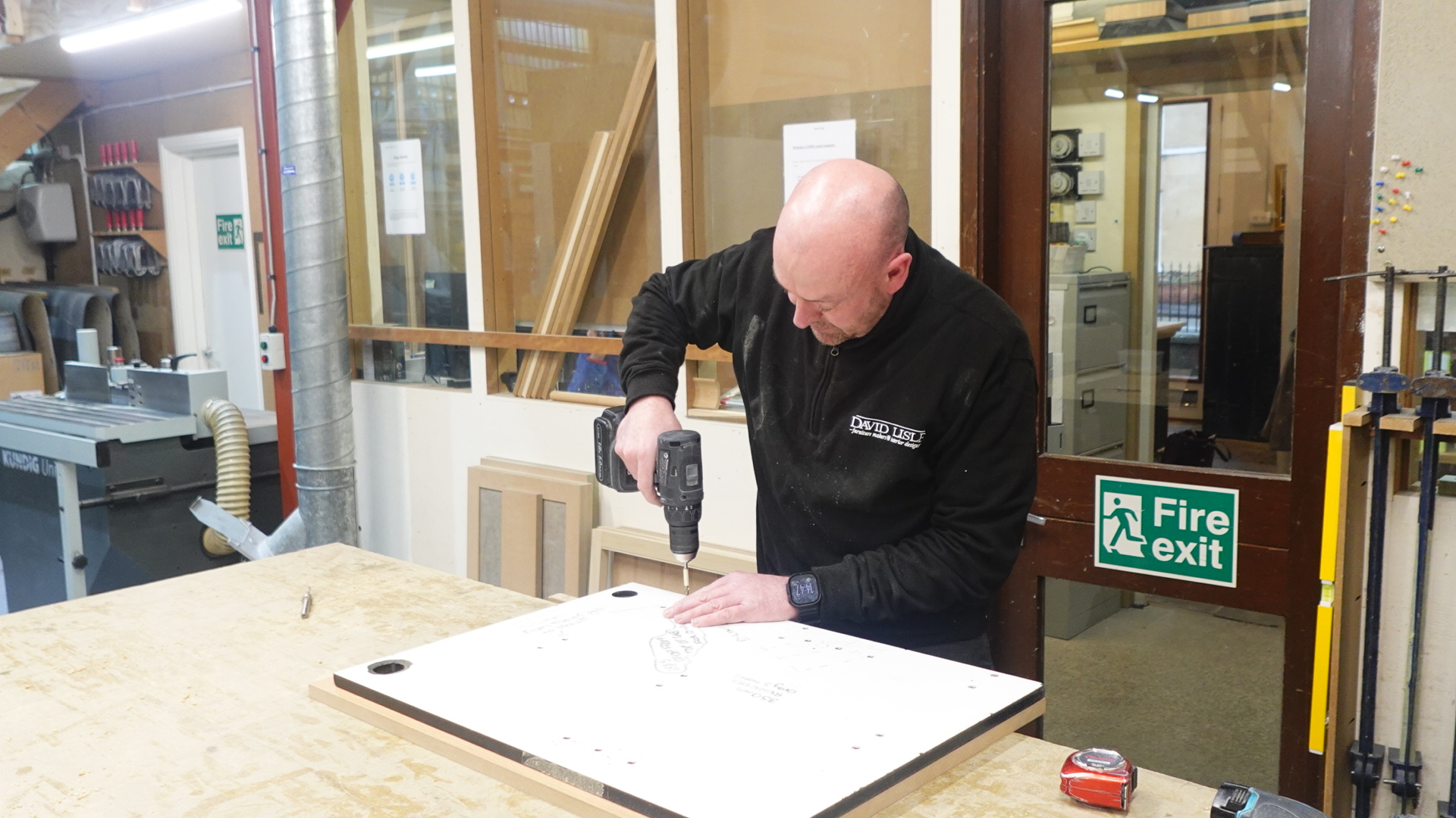 A tradesman working on a David Lisle luxury kitchen for a client in Wilmslow