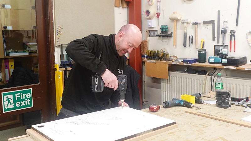A tradesman working on a David Lisle luxury kitchen for a client in Ormskirk