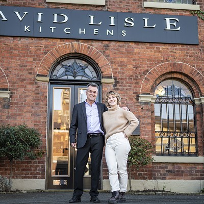 Photograph of David and Becky Lisle outside their Macclesfield showroom.